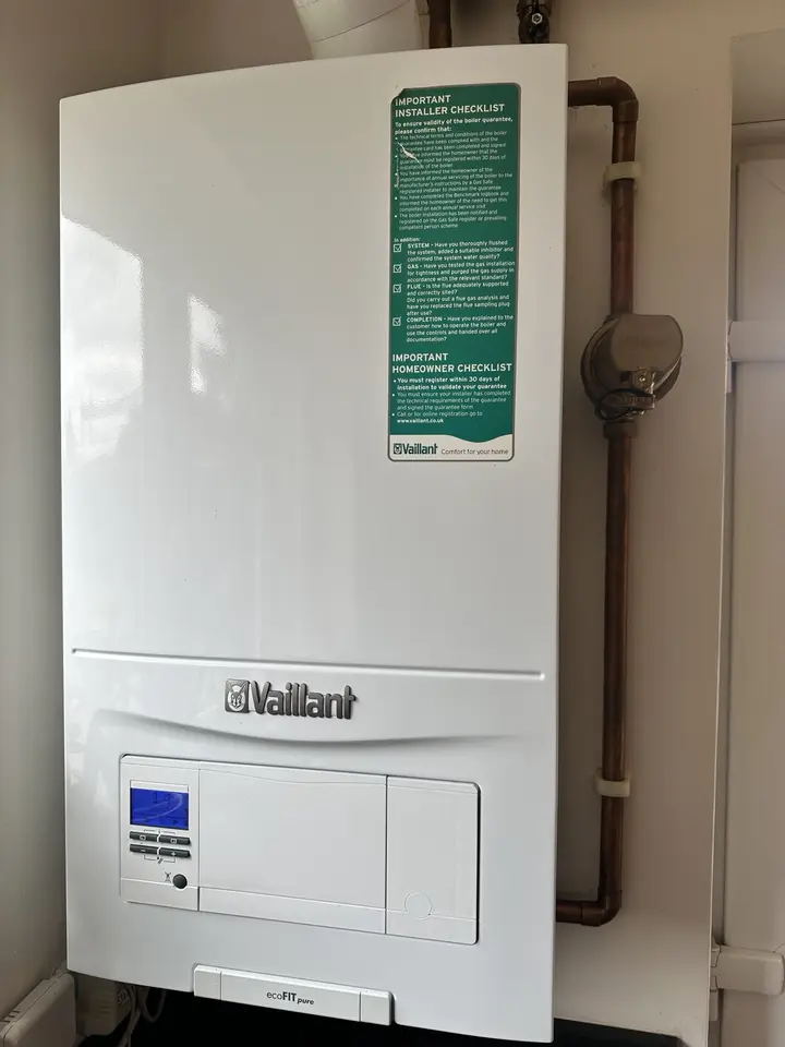A neatly installed Vaillant boiler with visible copper pipework